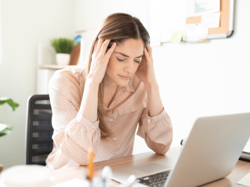 yound stressed out lady looking at laptop