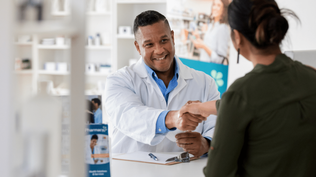 pharmacist shaking hands with patient