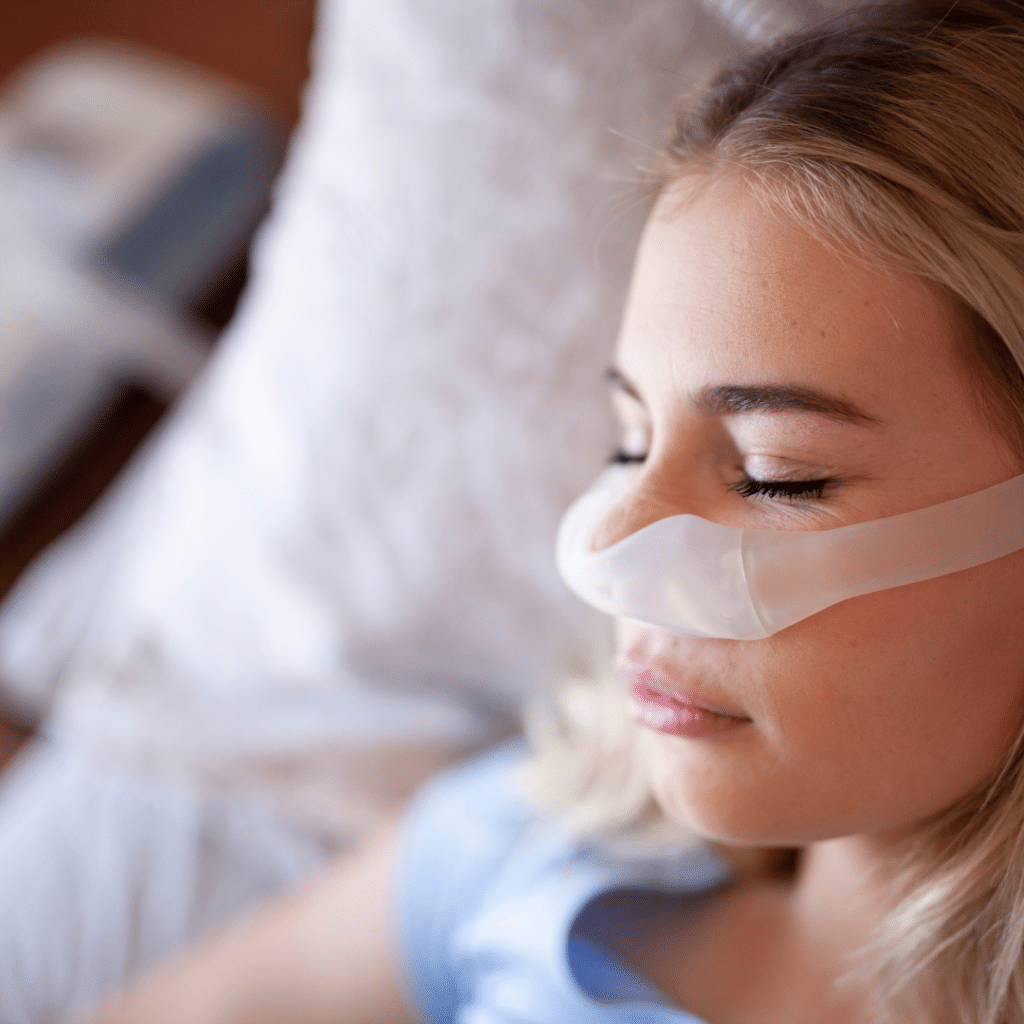 young lady with a nasal sleep apnea mask